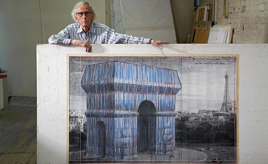 Christo in his New York studio in 2019, with a preparatory drawing for the project.