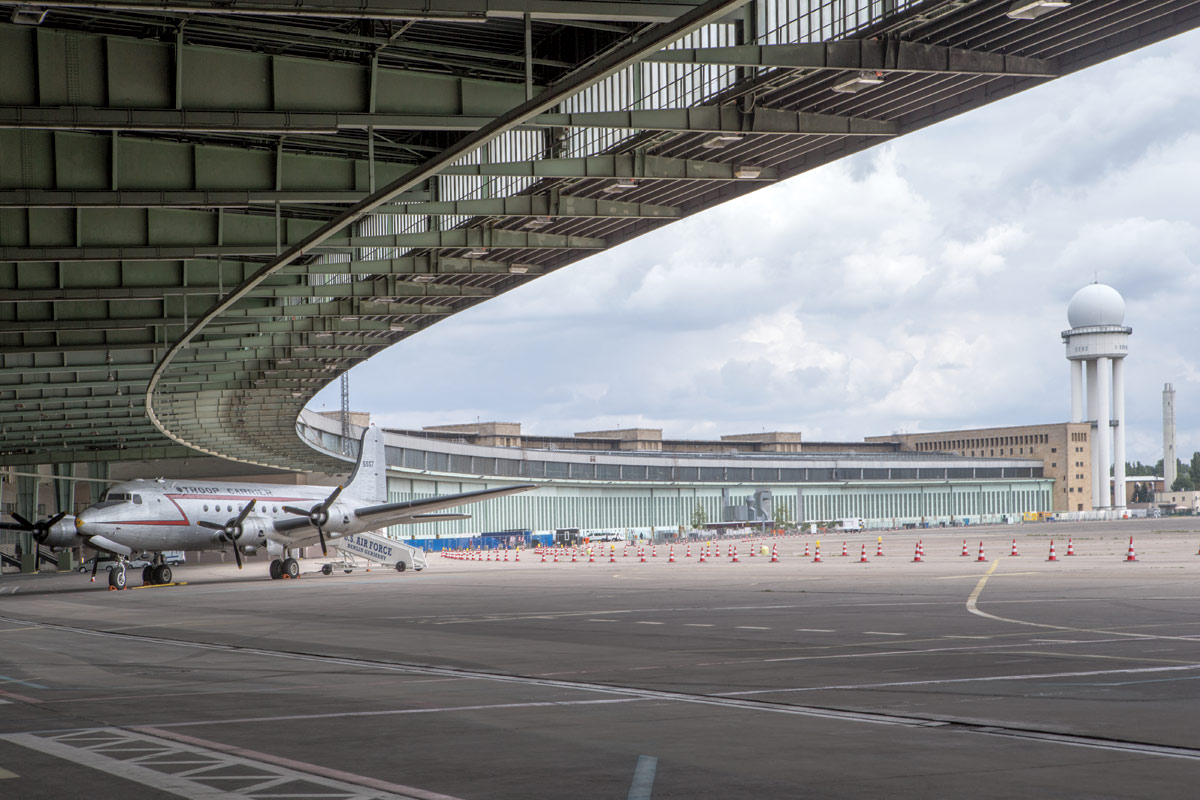 <br><h9>Tempelhof Airport by Ernst Sagebiel<br>Berlin, photo by Danica Kus, 2018</h9><p>   </p><h6><strong>DANICA KUS</strong><br>
Photographer based in Ljubljana and Antwerp<p>   </p>I use a digital DSLR camera, a Canon EOS-
1D X; I can’t think of the last time I used
artificial lighting. I generally use a Canon
24–70 millimeter lens as well as Canon
tilt-shift lenses. I prefer to shoot in blackand-
white—you can express more of your
feelings—but for assignments, I have to
shoot in color. I started my career working
in a darkroom, and the black you get there
is very different from the black you get
digitally. But, either way, I try to capture
that atmosphere of the space and the character
of the building—it’s my task to show
how you feel in the building. I pay attention
to the play of light, the sound, smell,
temperature, structures, rhythm, materials,
etc. Sometimes I try to create an
imaginary and ambiguous space with my
camera.<p>   </p>
Recently I photographed a school in
Brussels. It was quite difficult, because the
architects wanted to show the space being
used, but the school wouldn’t let me show
the students’ faces. And I couldn’t stay
more than about 20 minutes, because I was
interrupting classes. Once an architect
asked me to shoot a new office building
during the guided tour, which lasted less
than an hour—it was the only way to get
access to some of the spaces. It was difficult
because there was not enough time and
there were too many people, but, despite
the stress and speed, in the end, I was
satisfied. In fact, it was such a great experience
that, last summer, I shot Berlin’s
Tempelhof Airport during the guided tour.<p>   </p>
Sometimes, when I see the work of a
great architect, I’m overwhelmed. But if
the building isn’t beautiful, I look for something
else—how the light touches the walls
and floors. I always find something.</h6>