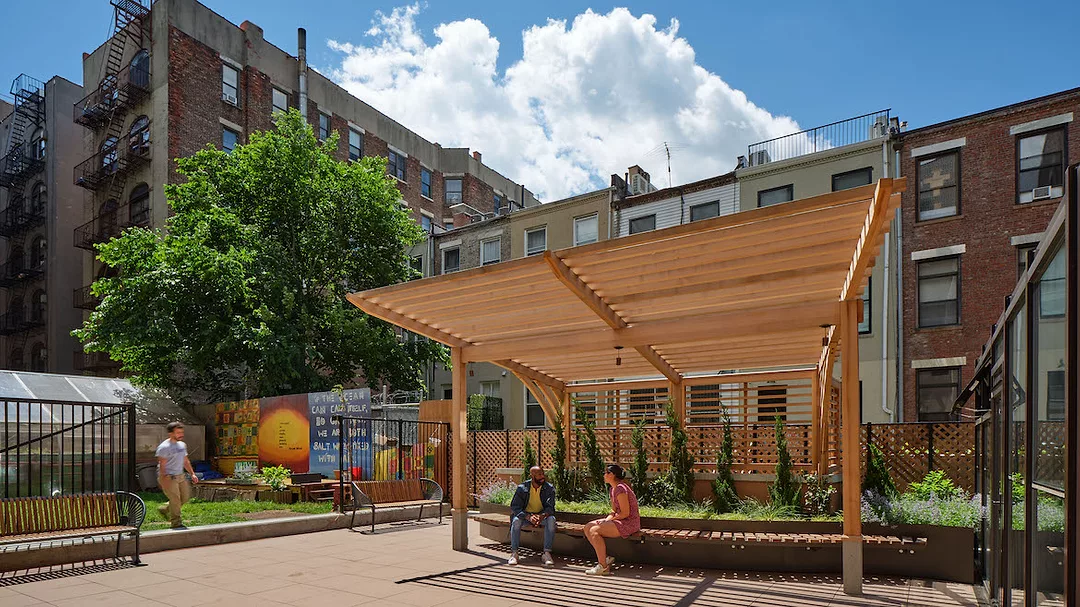 a community garden with shaded seating area