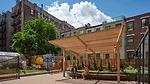 a community garden with shaded seating area