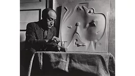 Isamu Noguchi with model for Contoured Playground, c. 1946. The Noguchi Museum Archives, 03775.