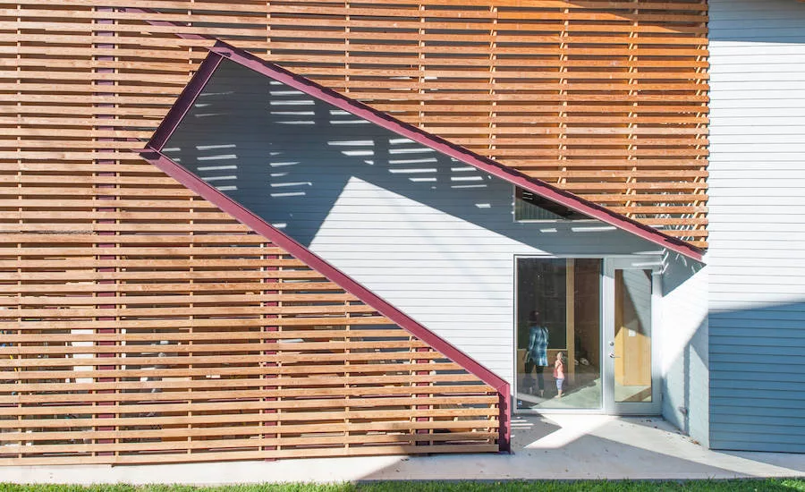 Shotgun Chameleon House main entrance and external staircase are on the side of the house