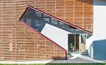 Shotgun Chameleon House main entrance and external staircase are on the side of the house