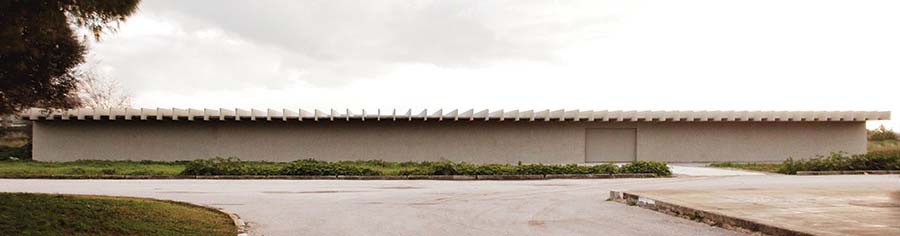 The Lebanon Pavilion's low horizontal concrete structure has a windowless facade.