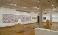 A 25-foot-long photomontage of the Olivetti mural in the Cooper Union show, with a tabletop sculpture in the center foreground.