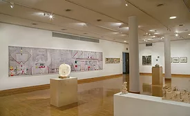 A 25-foot-long photomontage of the Olivetti mural in the Cooper Union show, with a tabletop sculpture in the center foreground.