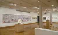 A 25-foot-long photomontage of the Olivetti mural in the Cooper Union show, with a tabletop sculpture in the center foreground.