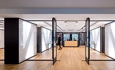 The crisply Miesian reception and exhibition area of NYU&rsquo;s Special Collections Library.