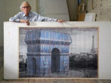 Christo in his New York studio in 2019, with a preparatory drawing for the project.
