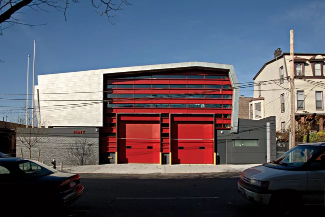 Ennead used immediately identifiable firehouse doors set into alternating glass and metal panels and wrapped in a form inspired by a firefighter's helmet for this Bronx station housing a specialized r