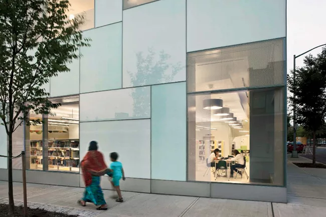 Colorful pathways and signage guide visitors through this new children's library adjacent to the borough's main branch, also master-planned by 1100 Architect. Activities inside connect to the surround