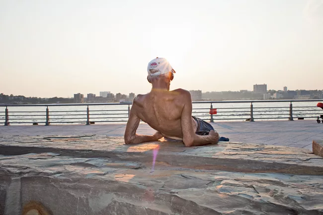A man lounges near Hudson River Park’s pedestrian path. The waterside park extends from Battery Park to 59th Street. The first section opened in 2003 and the five-mile stretch of greenery is now