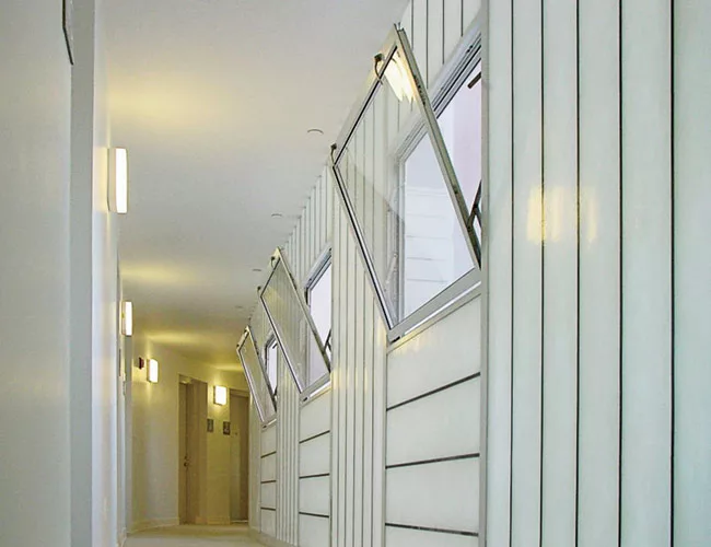 Inside, translucent sandwich panels admit daylight to the halls.