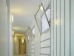 Inside, translucent sandwich panels admit daylight to the halls.