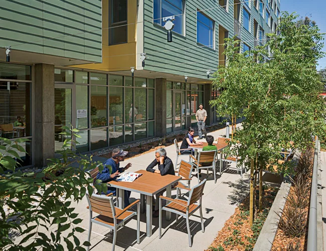 A variety of community multipurpose spaces on the ground floor connect to outdoor landscaped areas for the residents.
