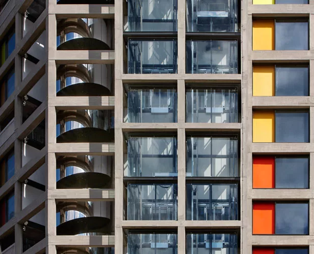 The renovated housing block includes a new, mirror-polished, steel-clad helical egress stair.