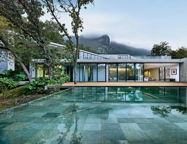 A concrete arch frames the view of the Mexican city, while serving as a kind of modern torii, or Japanese gate. The master-bedroom suite opens onto the pool terrace.