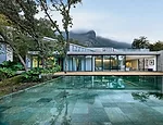 A concrete arch frames the view of the Mexican city, while serving as a kind of modern torii, or Japanese gate. The master-bedroom suite opens onto the pool terrace.