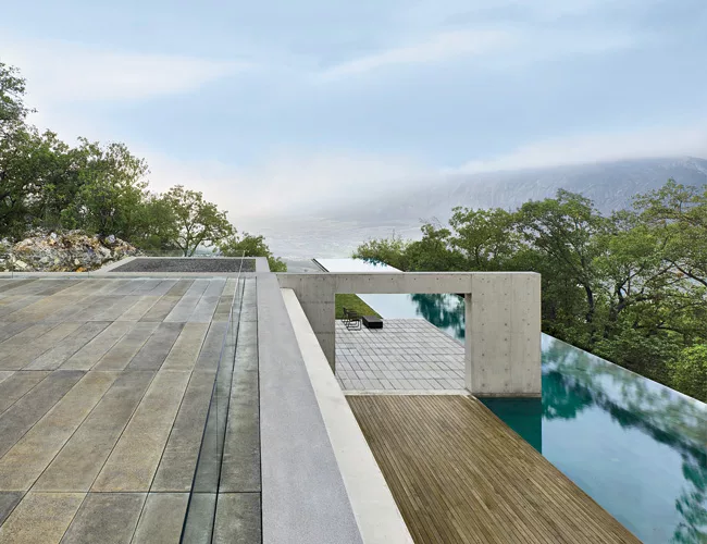 A 157-foot-long infinity pool reaches out beyond the hillside to the valley below.