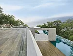 A 157-foot-long infinity pool reaches out beyond the hillside to the valley below.