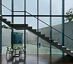 A pair of triangular courtyards contained within the center of the plan help anchor the private areas while bringing in daylight and outdoor views.