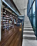 The library, which looks onto one of the courtyards, helps connect the public and private zones and is one of the most dramatic spaces in the house. The complex relationship between indoors and out ha