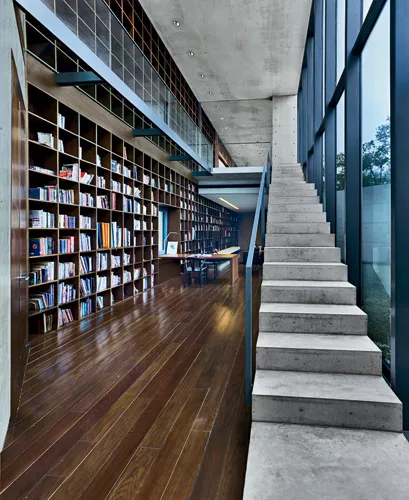 The library, which looks onto one of the courtyards, helps connect the public and private zones and is one of the most dramatic spaces in the house. The complex relationship between indoors and out ha
