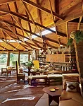 The outstanding feature of the lodge is the living room, where the ceiling rises to a 28-foot height. At the perimeter, the roof drops to an 11-foot height, underscored by a flared rim that runs aroun