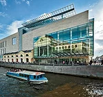 Glimpses of the past appear on the glazing around the entrance of the Mariinsky II as it reflects its 19th-century Rococo predecessor across the Kryukov Canal and a reconstructed fragment of the c