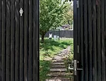 The architect's transparent stall (for women primarily) is surrounded by a 7-foot-high oval of wood fencing. The fence allows the stall's users to experience the scenic view while main