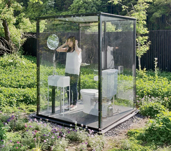 The architect's transparent stall (for women primarily) is surrounded by a 7-foot-high oval of wood fencing. The fence allows the stall's users to experience the scenic view while main