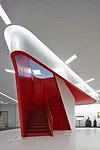A new red stair by Hitoshi Abe leads from a shopping area on the first floor to a dining area on the second floor.
