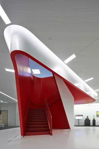 A new red stair by Hitoshi Abe leads from a shopping area on the first floor to a dining area on the second floor.