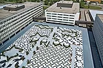 Abe and his team transformed a visitors&rsquo; parking lot (slide 3) at the center of the site into a plaza shared by all the surrounding buildings. Concrete benches and planters divide the large spac