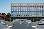 Abe and his team transformed a visitors&rsquo; parking lot (slide 3) at the center of the site into a plaza shared by all the surrounding buildings. Concrete benches and planters divide the large spac