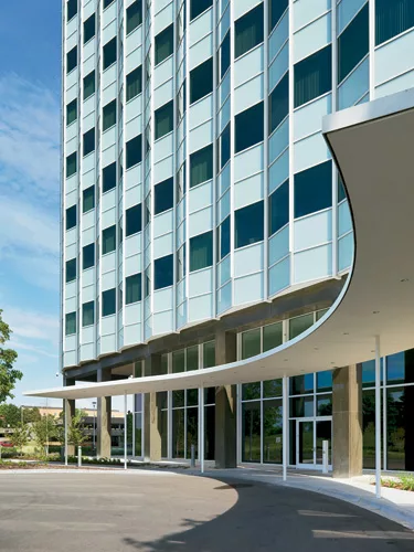 Peter Ebner designed a new canopy for the south side of Building 220 where visitors now pull up (left). He also designed the landscaping in front of the building, as part of the entry sequence.