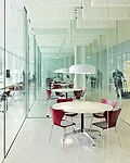 On the first floor of Building 220, Ebner created a series of glass cubes that serve as impromptu meeting rooms, adjacent to a long space that faces the plaza and provides a variety of furniture for i