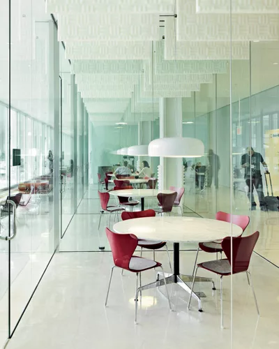 On the first floor of Building 220, Ebner created a series of glass cubes that serve as impromptu meeting rooms, adjacent to a long space that faces the plaza and provides a variety of furniture for i