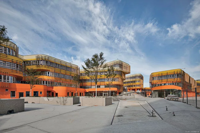 CRAB studio’s colorful building snakes around a series of courtyards and outdoor spaces.