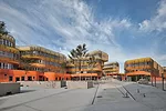 CRAB studio’s colorful building snakes around a series of courtyards and outdoor spaces.