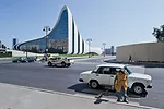 The unbridled swooping forms and blinding brightness of the glass-fiber-reinforced plastic exterior carry through to the building’s interiors, where floors merge into walls, stairs, and 