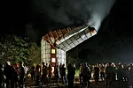 During the weekend celebration, photographer Timothy Hursley hosted a bonfire party at the silo he owns in a remote pasture. The deformed structure was reportedly the victim of a tornado.
