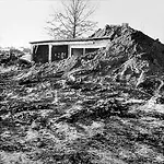 Robert Smithson created P<em>artially Buried Woodshed</em>, 1970 by piling earth onto a shed on the grounds of Kent State University in Ohio until its structure gave way.