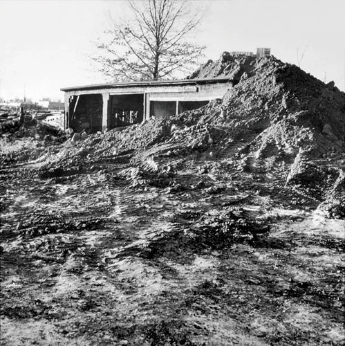 Robert Smithson created P<em>artially Buried Woodshed</em>, 1970 by piling earth onto a shed on the grounds of Kent State University in Ohio until its structure gave way.