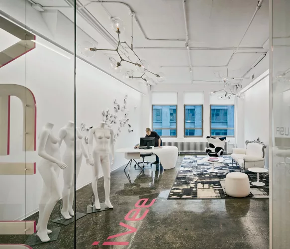 The reception area is furnished with found art and idiosyncratic furniture, to give the space the energy and insouciance it purveys in its business.