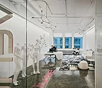The reception area is furnished with found art and idiosyncratic furniture, to give the space the energy and insouciance it purveys in its business.