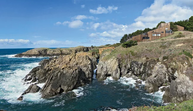 Condominium One, in all its rustic majesty, presides over an outcropping above the Pacific.