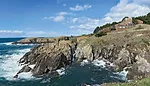 Condominium One, in all its rustic majesty, presides over an outcropping above the Pacific.