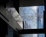 The glass facade refracts, deflects, and reflects light, creating optical illusions for those inside the building. People, cars, and other buildings seem to appear where they are not. 