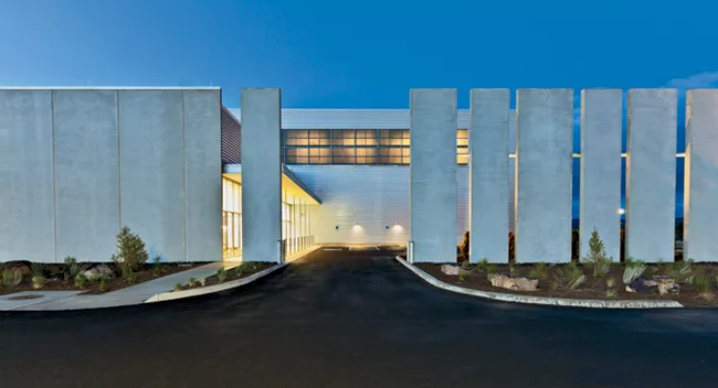 To complement the desert surroundings, the architects used earthtoned concrete panels for the perimeter wall and landscaped with large rocks salvaged on the site during construction.